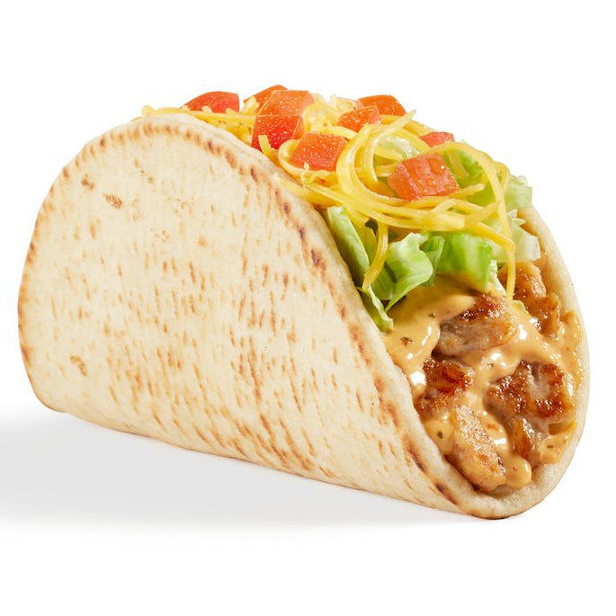 A soft taco filled with shredded yellow cheese, diced red tomatoes, green lettuce, and chicken in a creamy sauce.
